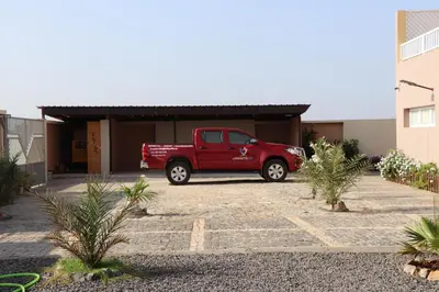 a red truck parked in front of a building at LAFAYETTE Alojamentos in Espargos