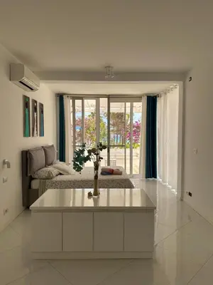 a white living room with a couch and a table at Villa Cristina Alojamento, Praia de Chaves, Boa Vista, Cape Verde, WI-FI in Sal Rei