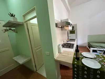 a small kitchen with a table with a bottle of wine at B&B Mi Ma Bo, Sal Rei, Boa Vista, Cape Verde, FREE WI-FI in Sal Rei