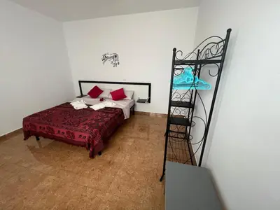 a bedroom with a bed and a ladder at FRANMAY APARTMENTS - 7 modern apartments near the beach & city in Santa Maria