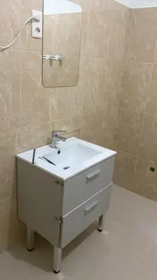 a bathroom with a white sink and a mirror at Maison Residencial casa de ferias in Pedra Badejo