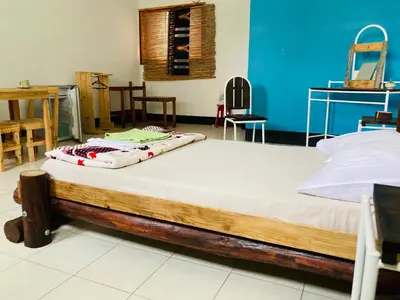a bed in a room with a wooden frame at Pedra de Rala in Porto Novo