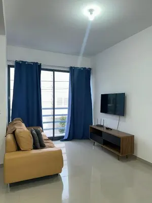 a living room with a couch and a television at Apartamento Novo, Brand New Apartament T1, Cidadela, Praia, Cabo Verde in Praia