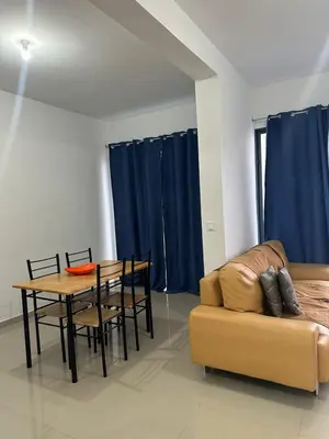 a living room with a table and a couch at Apartamento Novo, Brand New Apartament T1, Cidadela, Praia, Cabo Verde in Praia