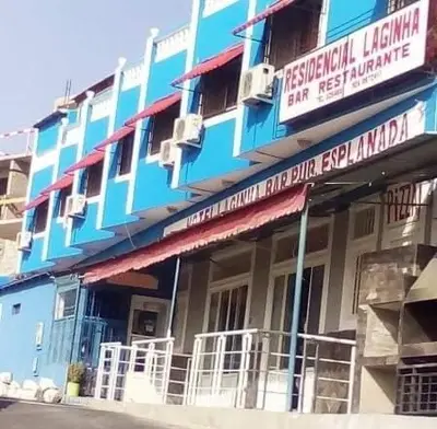 a blue building with signs on the side of it at Residencial Laginha in Mindelo