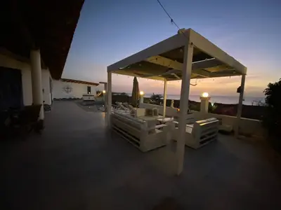 a large pavilion on the roof of a house at L' Ancora - Room With Exclusive Pool And Terrace in Palmeira