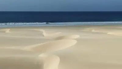a beach with white sand and the ocean at Ca'Claudia Boavista in Sal Rei