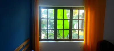 a window in a room with an orange curtain at Rose`s place in Mindelo