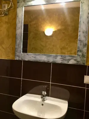 a bathroom with a sink and a mirror at Ca GIOgió in Santa Maria