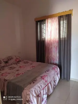 a bedroom with a bed and a window at Guest House Maio in Vila do Maio