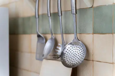 four utensils are hanging on a wall at Lovely beach front apartment in Santa Maria in Santa Maria
