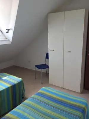 a bedroom with a bed and a cabinet and a chair at Leme Bedje GST84 3 bedroom apt with Panaramic views in Santa Maria