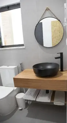 a bathroom with a black bowl sink on a wooden counter at Urban Sal Loft in Espargos