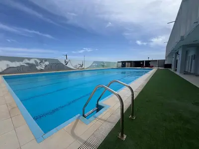 a large swimming pool with blue water on a building at Académico do Sal in Espargos