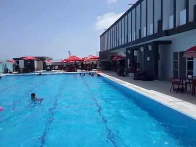 a person in a swimming pool next to a building at Académico do Sal in Espargos