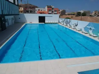 a large swimming pool with blue water at Académico do Sal in Espargos