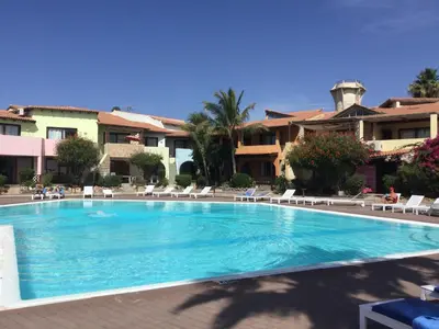 a swimming pool in front of a resort at Apt14 Porto Antigo 1 with Pool and Beach views in Santa Maria