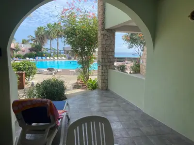 a patio with a view of a swimming pool at Apt14 Porto Antigo 1 with Pool and Beach views in Santa Maria