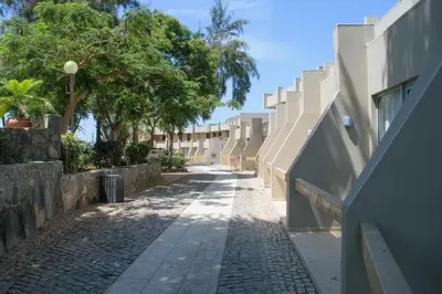 an empty street with trees and a building at Oasis Praiamar in Praia