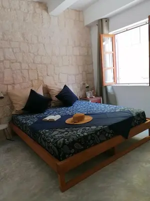 a bedroom with a bed with a hat on it at Villa Pescadora spectacular view, luxery fisherhouse design in Sal Rei