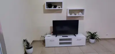a flat screen tv on a white stand in a room at Apartamento Teixeira in Espargos