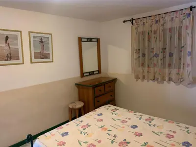 a bedroom with a bed and a dresser and a mirror at Beach Townhouse - Murdeira Village in Beirona