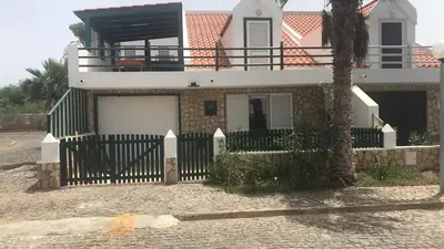 a house with a fence in front of it at Beach Townhouse - Murdeira Village in Beirona