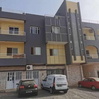 two cars parked in a parking lot in front of a building at Ellen Apartamento T0 - Inforsal in Espargos