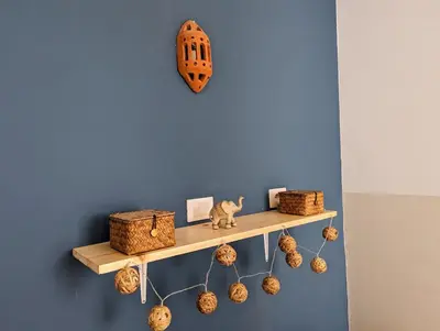 a shelf on a blue wall with a cat sitting on it at Tropical Leaves Sea view penthouse ca Greta 2 floor in Sal Rei