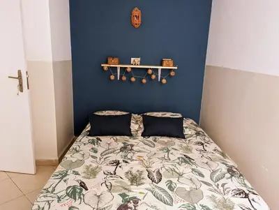 a bedroom with a bed and a blue wall at Tropical Leaves Sea view penthouse ca Greta 2 floor in Sal Rei