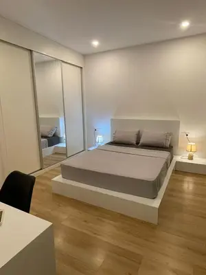 a bedroom with a large bed and a large mirror at Duarte Apartments - Lux in Mindelo