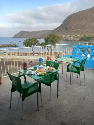 a table and chairs with a view of the ocean at Hotel Sol Marina in Tarrafal