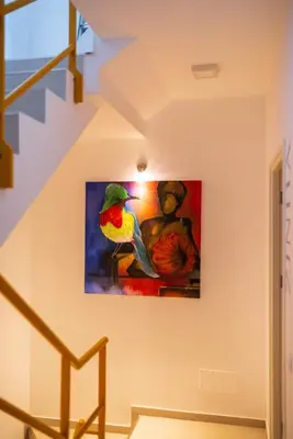 a painting of a bird on a wall at Apartamento Augusta Amwilla Guesthouse in Mindelo