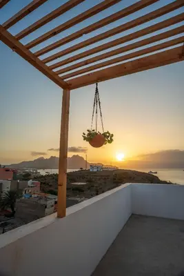 a view of the sunset from the balcony of a house at Apartamento Augusta Amwilla Guesthouse in Mindelo