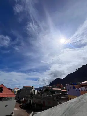 a view of a city with the sun in the sky at Casa BB&Djassi - SUITES in Ponta do Sol