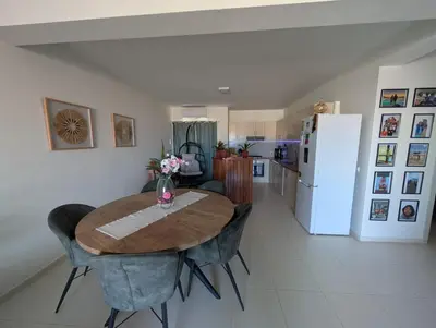 a kitchen and dining room with a wooden table and chairs at Casa Relaxod in Santa Maria