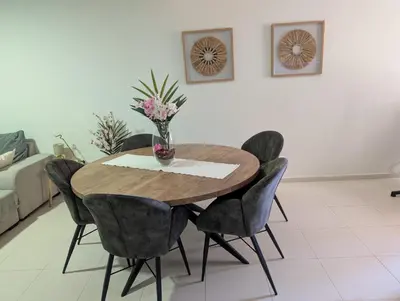 a dining room table with chairs and a vase with flowers at Casa Relaxod in Santa Maria
