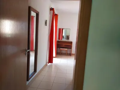 a hallway with a door and a mirror and a sink at Apartamento Privado Vila Verde in Santa Maria