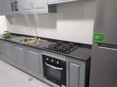 a kitchen with a stove and a sink at Apartamento T1 Moderno com Wi-Fi in Praia