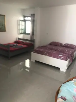 a bedroom with two beds and a window at Apartamento T1 Moderno com Wi-Fi in Praia