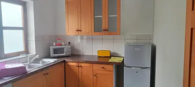 a kitchen with a sink and a refrigerator at casa verde lucas in Mindelo
