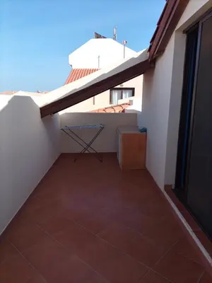 a small balcony with a table on a roof at Porto Antigo 2 Apt 72 TOP FLOOR WITH SEA VIEW in Santa Maria