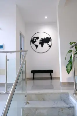 a black bench in a white room with a clock on the wall at VILLA NAYELI Luxury and Simplicity in Órgãos