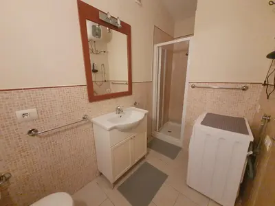 a bathroom with a sink and a toilet and a mirror at Appartement Amalia Sal Santa Maria in Prainha