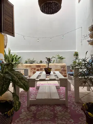 a living room with a table and potted plants at Casa Carlotta - Authentic Stay in Maio in Vila do Maio