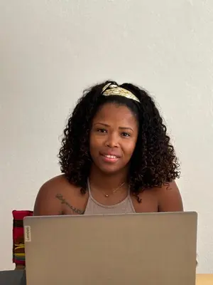 a woman sitting in front of a laptop computer at Casa Carlotta - Authentic Stay in Maio in Vila do Maio