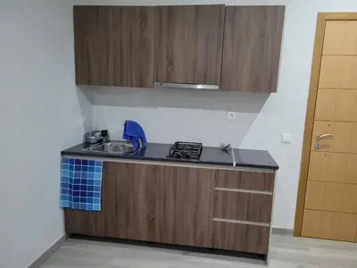 a small kitchen with a sink and a stove at ENZO APARTAMENTO T0 - Inforsal in Espargos