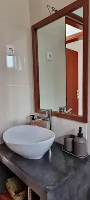 a bathroom with a large white sink and a mirror at Kasa d'Vizin in Paul