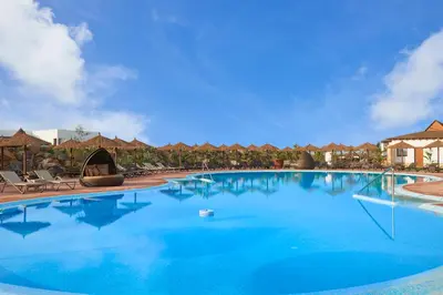 a large pool with chairs and umbrellas at a resort at Melia Llana Beach Resort & Spa - Adults Only - All Inclusive in Santa Maria