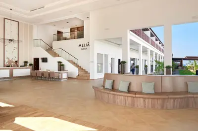 a lobby of a mall with a staircase and a couch at Melia Llana Beach Resort & Spa - Adults Only - All Inclusive in Santa Maria